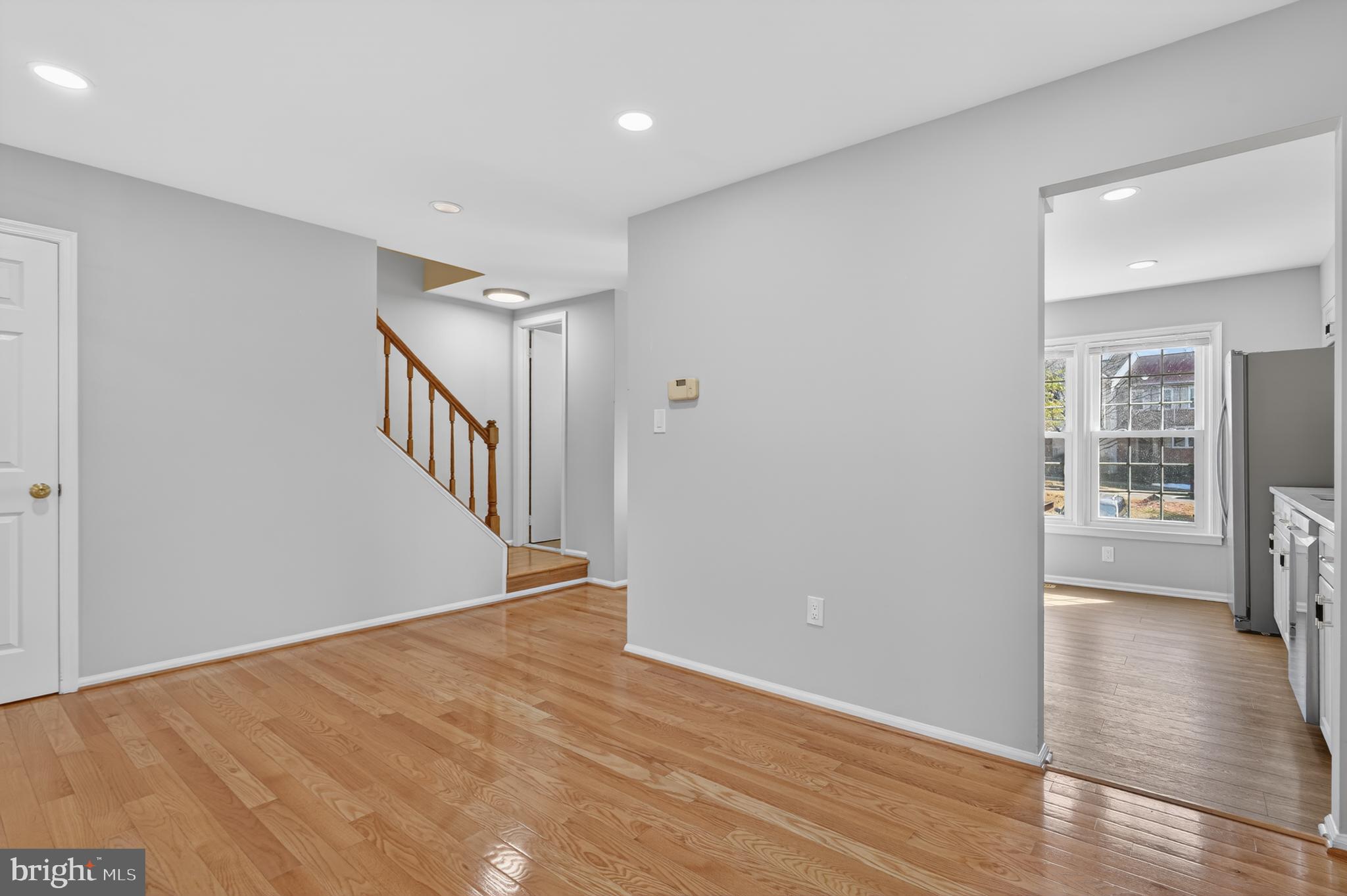8868 Winding Hollow Way Springfield, VA 22152 - Photo 14 of 53 a view of an empty room with wooden floor and a window