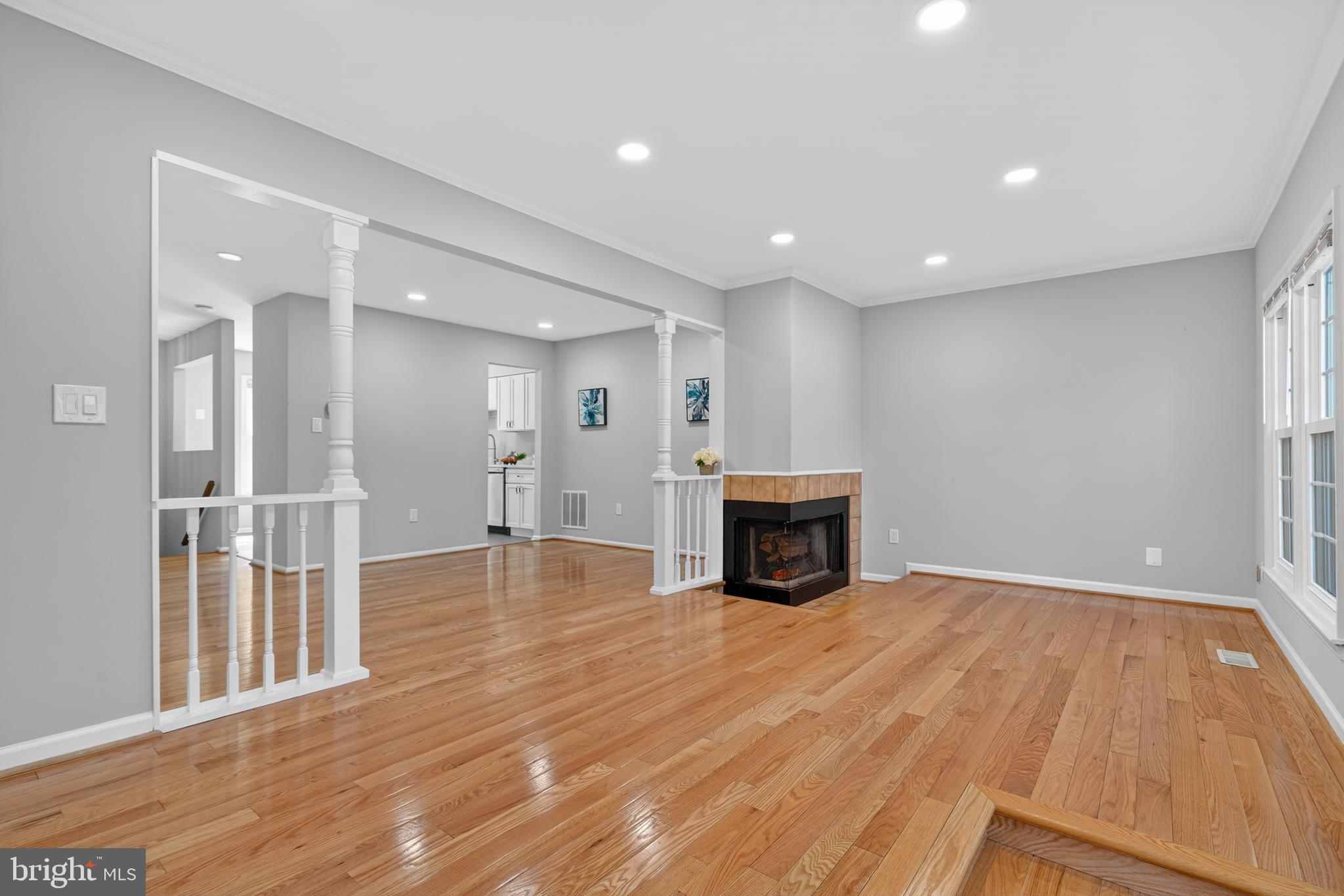 8868 Winding Hollow Way Springfield, VA 22152 - Photo 16 of 53 a view of empty room with wooden floor and fireplace