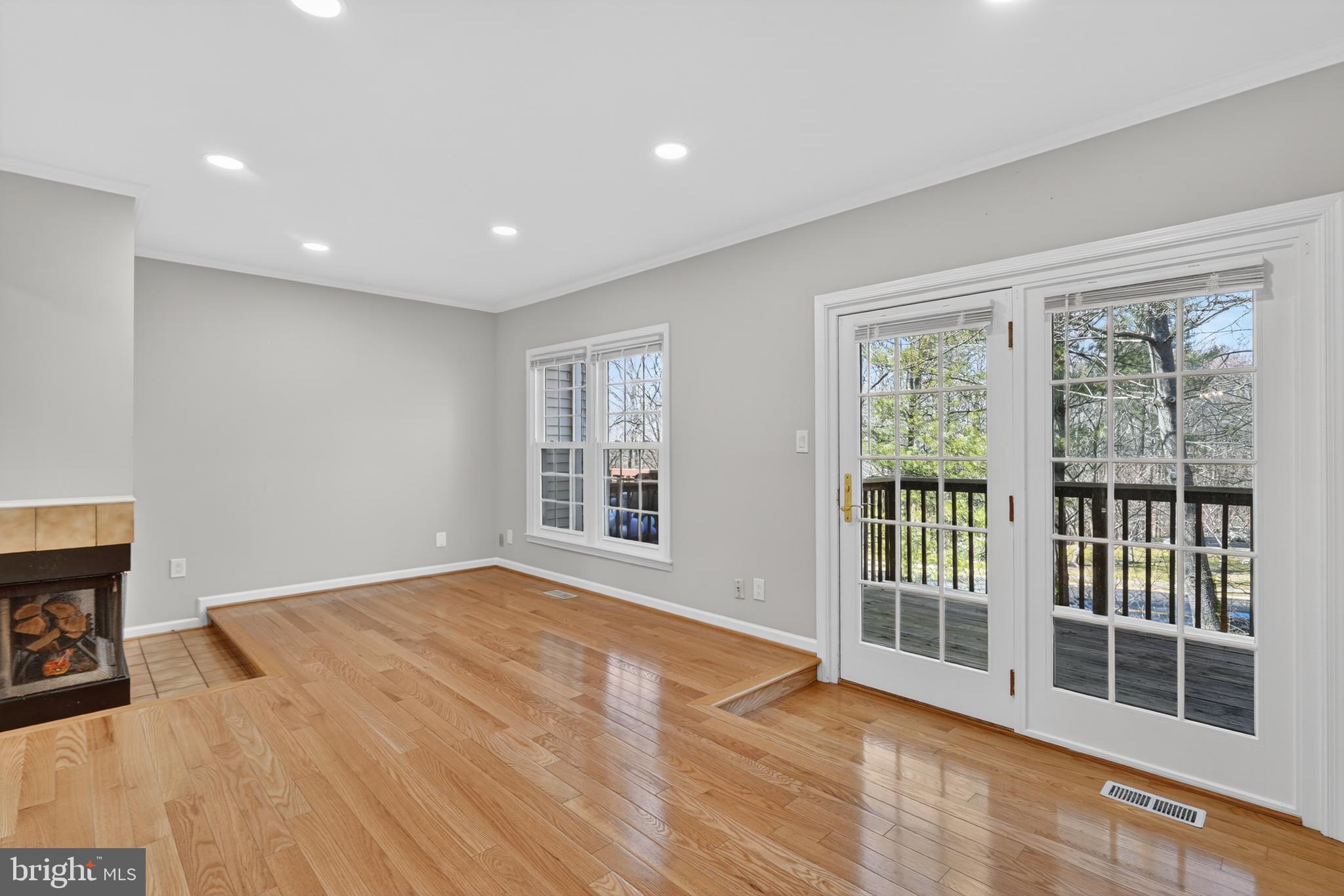8868 Winding Hollow Way Springfield, VA 22152 - Photo 17 of 53 a view of an empty room with a window and wooden floor