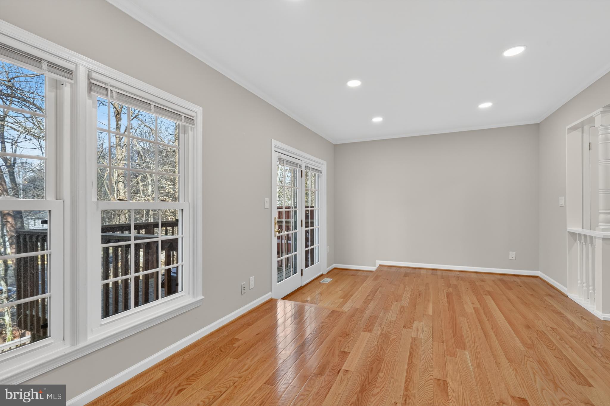 8868 Winding Hollow Way Springfield, VA 22152 - Photo 18 of 53 a view of an empty room with wooden floor and a window