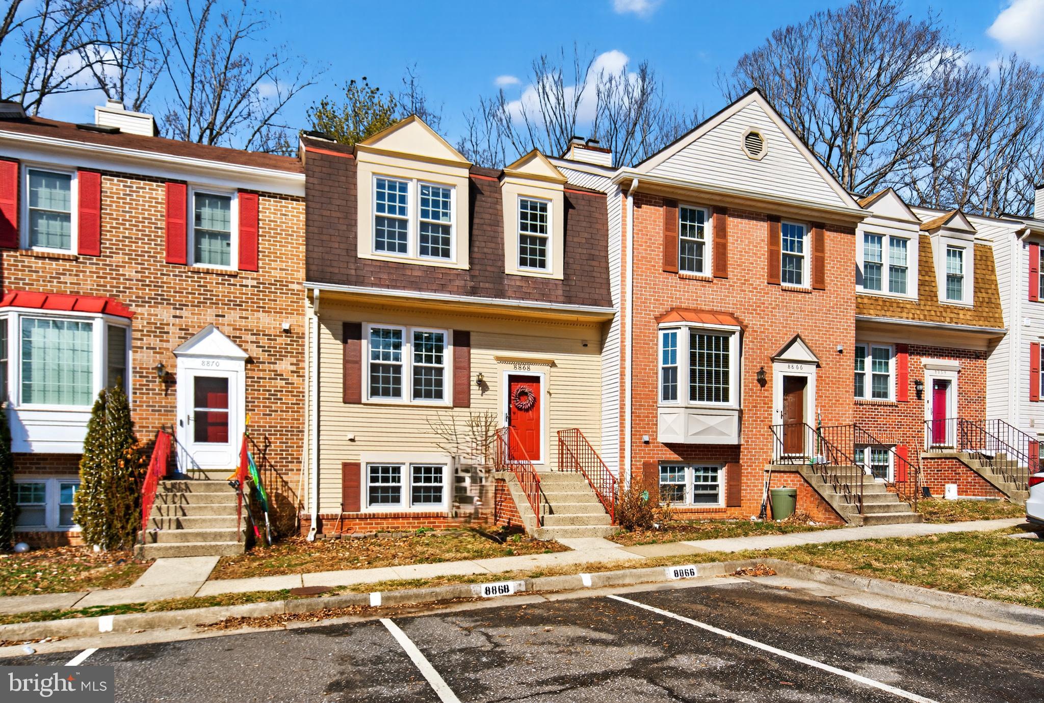 8868 Winding Hollow Way Springfield, VA 22152 - Photo 2 of 53 a front view of a residential apartment building with a yard