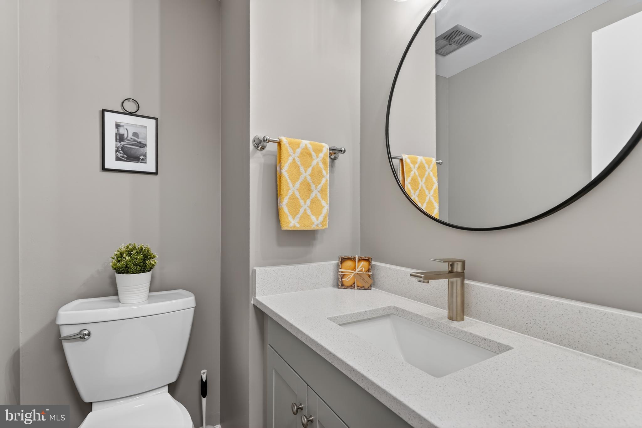 8868 Winding Hollow Way Springfield, VA 22152 - Photo 22 of 53 a bathroom with a toilet a sink and a mirror