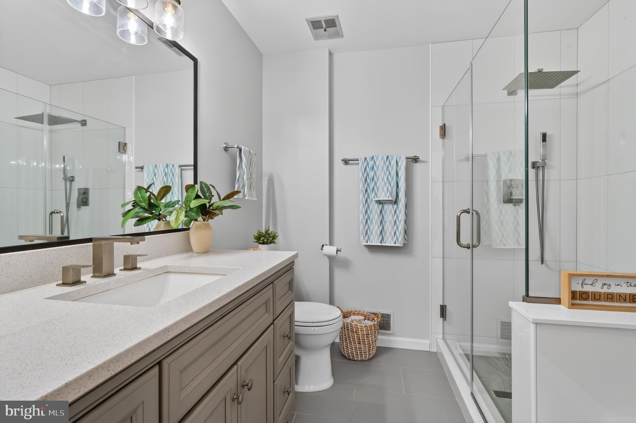 8868 Winding Hollow Way Springfield, VA 22152 - Photo 26 of 53 a bathroom with a granite countertop sink a toilet and shower