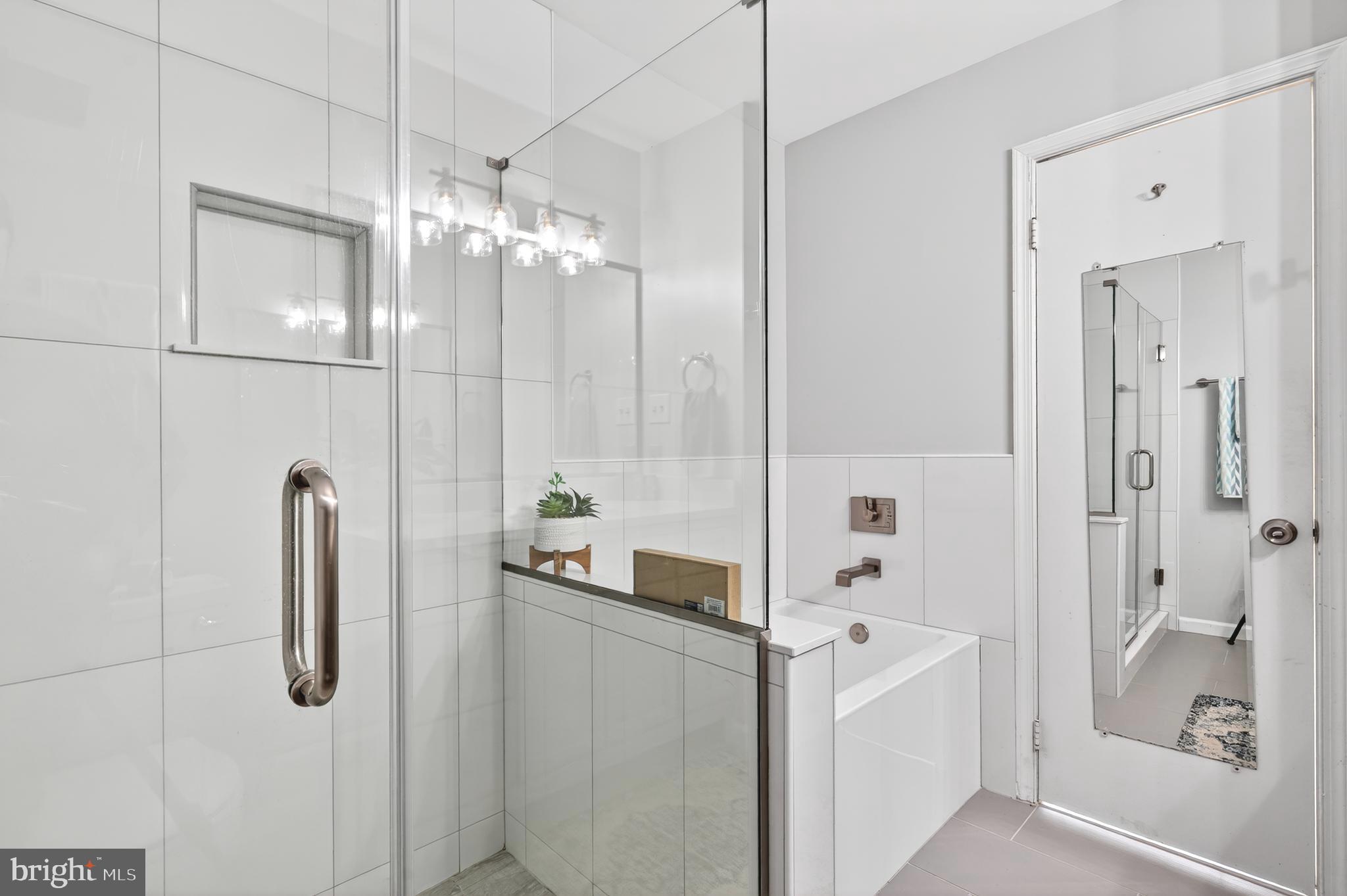 8868 Winding Hollow Way Springfield, VA 22152 - Photo 27 of 53 a bathroom with a shower tub and shower