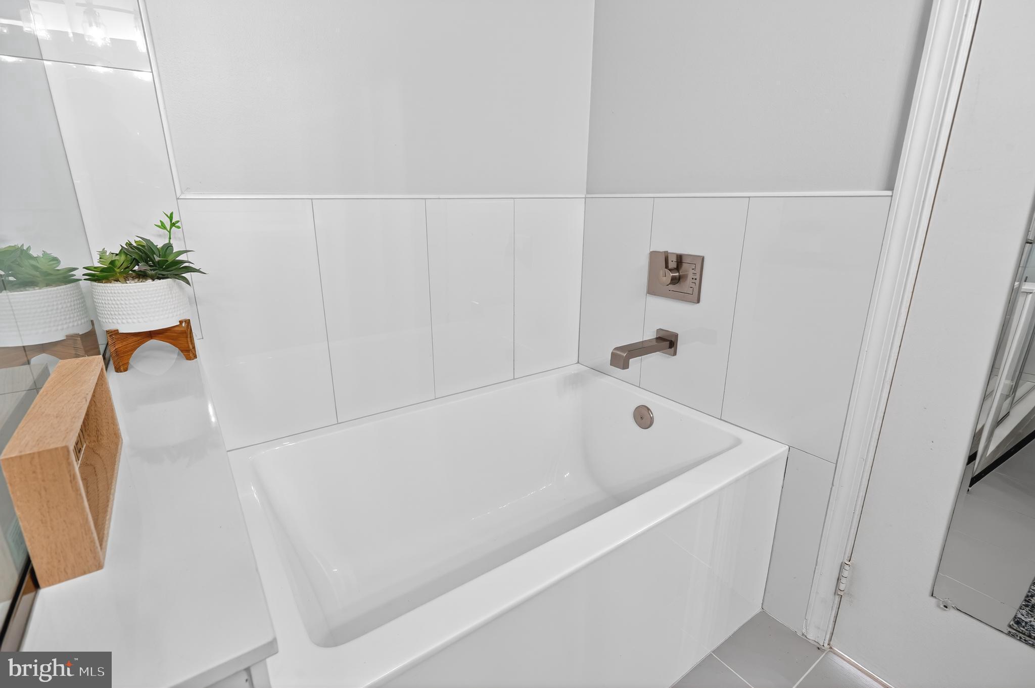 8868 Winding Hollow Way Springfield, VA 22152 - Photo 28 of 53 a bathroom with a tub and sink