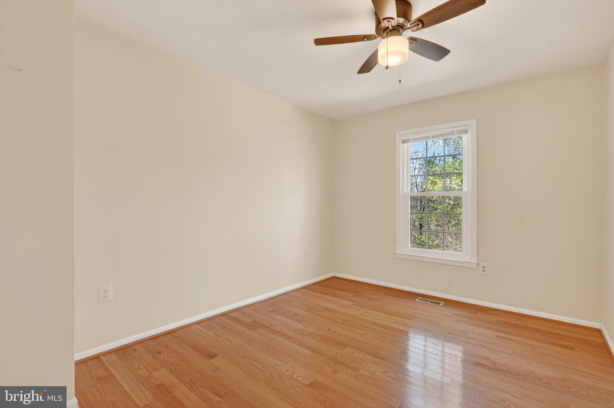 8868 Winding Hollow Way Springfield, VA 22152 - Photo 29 of 53 an empty room with a window and a fan