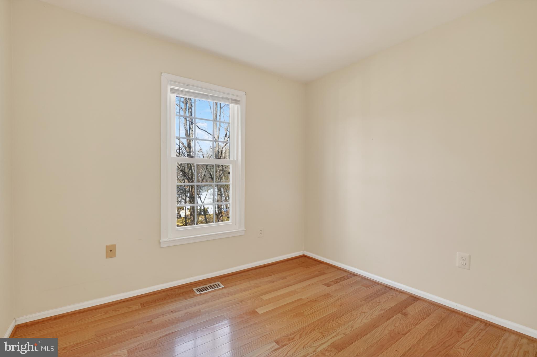 8868 Winding Hollow Way Springfield, VA 22152 - Photo 31 of 53 an empty room with wooden floor and windows