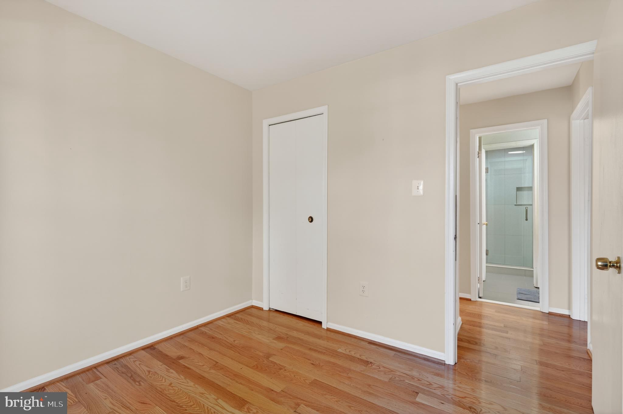 8868 Winding Hollow Way Springfield, VA 22152 - Photo 32 of 53 a view of an empty room with wooden floor and closet