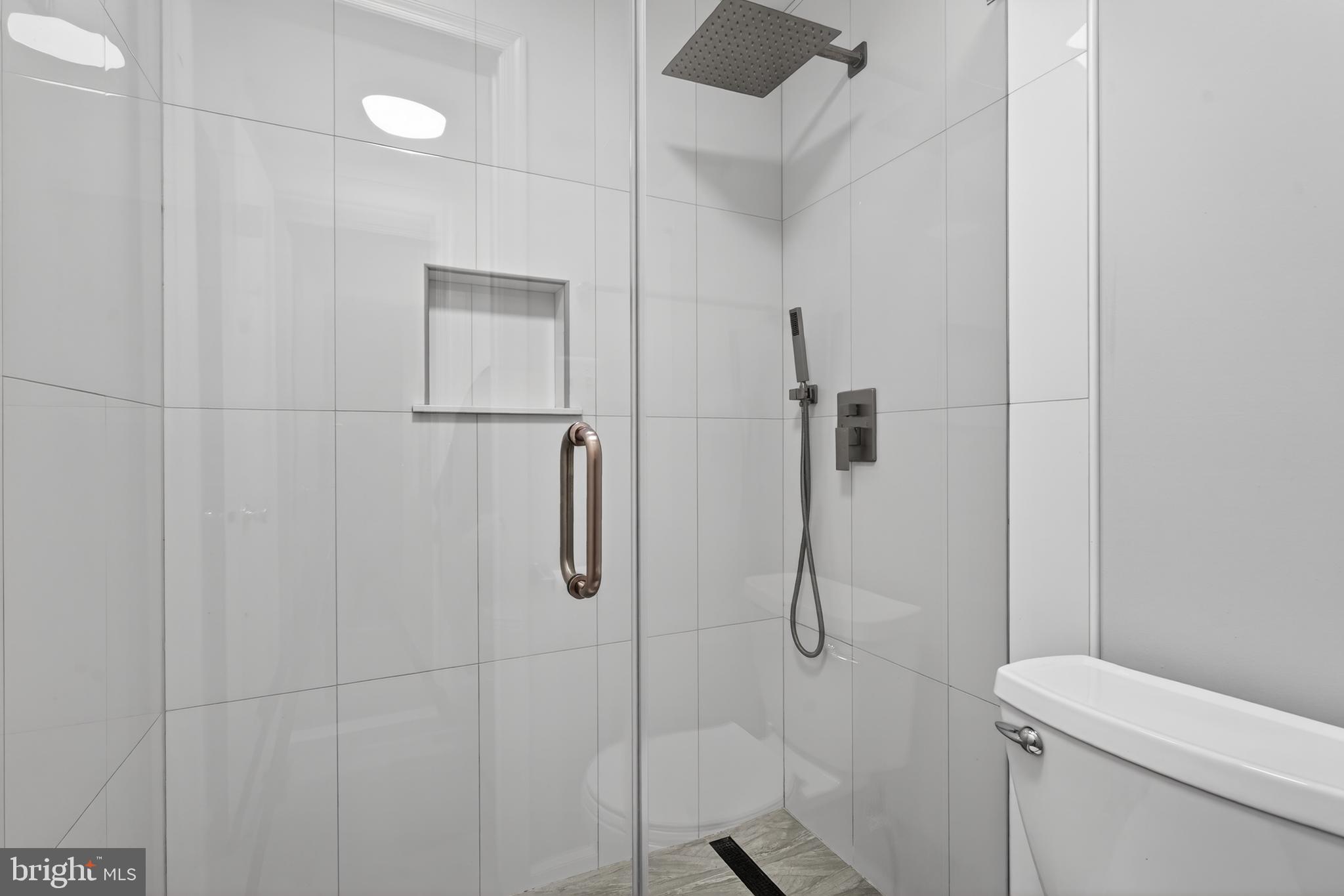 8868 Winding Hollow Way Springfield, VA 22152 - Photo 34 of 53 a bathroom with a shower and toilet