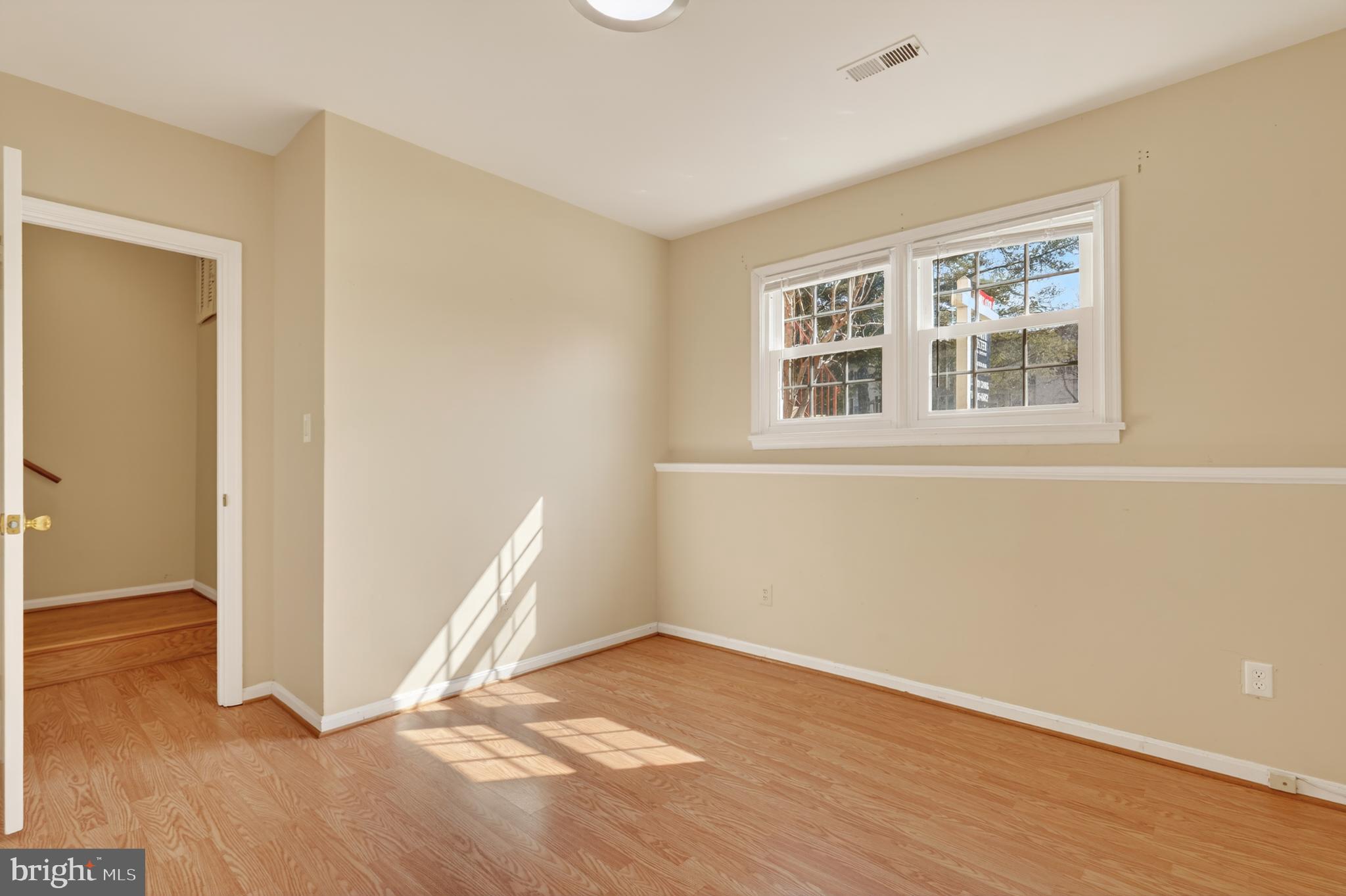 8868 Winding Hollow Way Springfield, VA 22152 - Photo 35 of 53 an empty room with wooden floor and windows