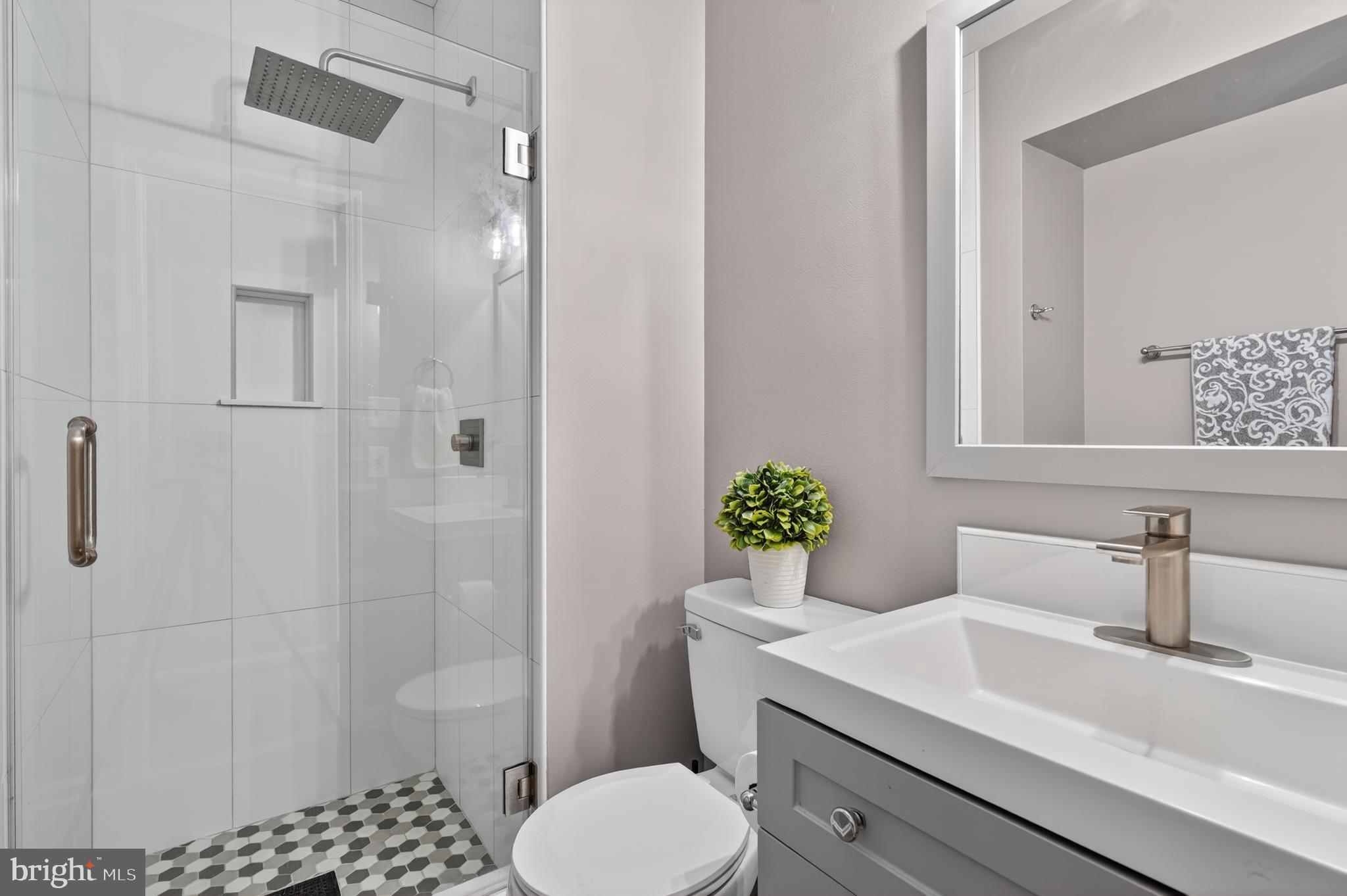 8868 Winding Hollow Way Springfield, VA 22152 - Photo 38 of 53 a bathroom with a sink toilet and shower