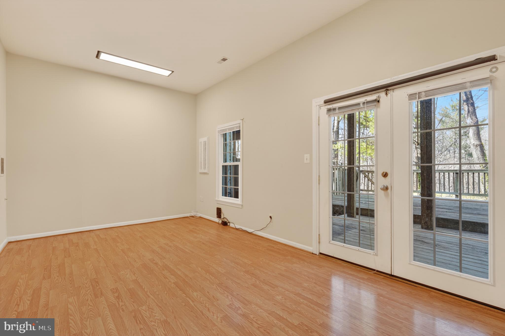 8868 Winding Hollow Way Springfield, VA 22152 - Photo 39 of 53 a view of an empty room with wooden floor and a window