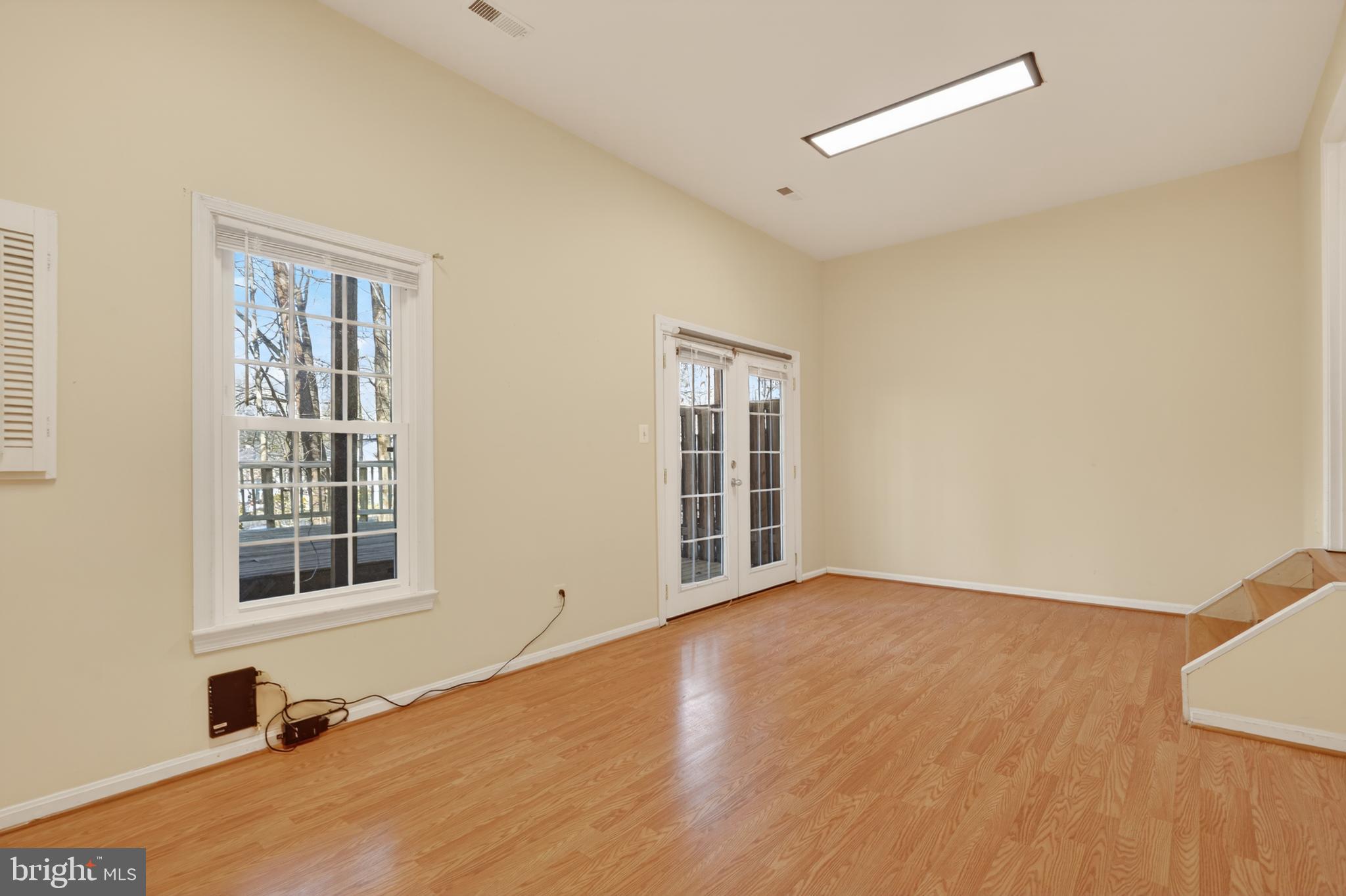 8868 Winding Hollow Way Springfield, VA 22152 - Photo 40 of 53 a view of an empty room with a window and wooden floor