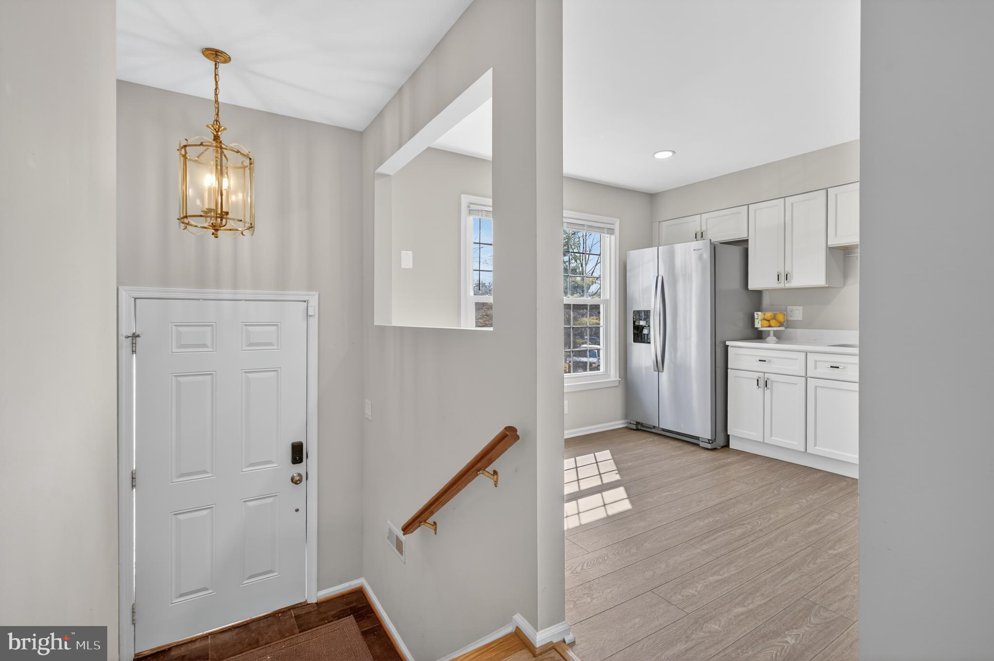 8868 Winding Hollow Way Springfield, VA 22152 - Photo 5 of 53 a view of a kitchen with refrigerator and wooden floor