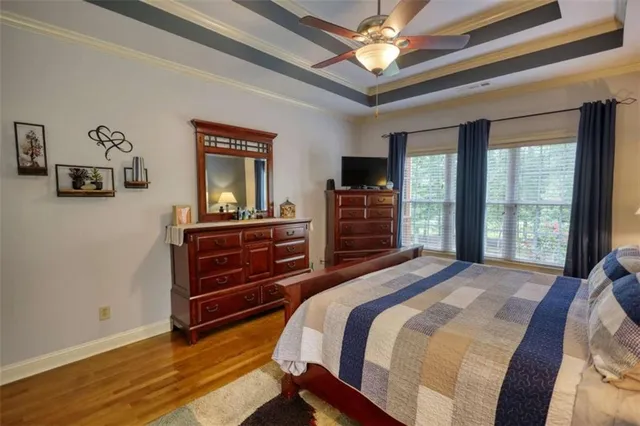 a bedroom with a large bed and a chandelier