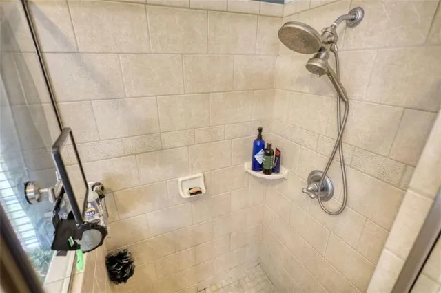 a living room with furniture a flat screen tv and a chandelier