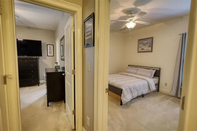 a view of a house with a yard and large trees