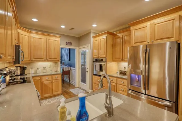 an aerial view of a house with a yard and lake view