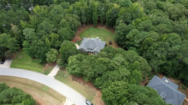 an aerial view of a house with a yard
