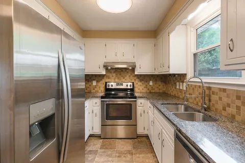 a kitchen with a stove microwave and refrigerator