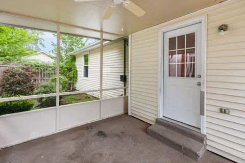 a view of a house with a window and wooden walls