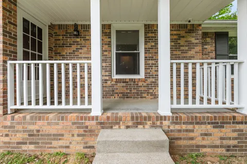 a view of a brick house with many windows
