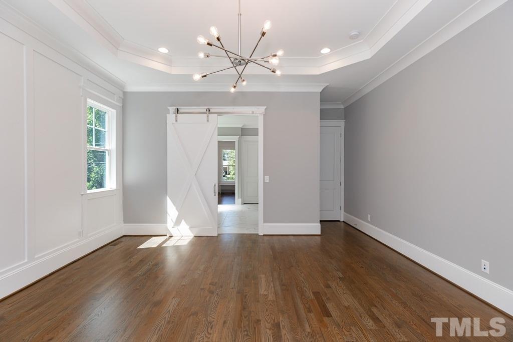 3319 Lake Boone Trail Raleigh, NC 27607 - Photo 11 of 30 a view of an empty room with wooden floor and a window