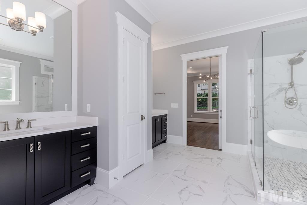 3319 Lake Boone Trail Raleigh, NC 27607 - Photo 14 of 30 a spacious bathroom with a granite countertop sink a toilet a mirror and shower