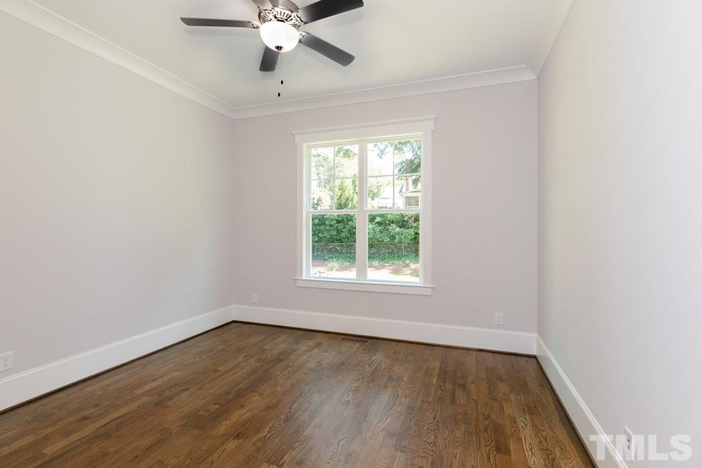 3319 Lake Boone Trail Raleigh, NC 27607 - Photo 17 of 30 an empty room with wooden floor fan and windows