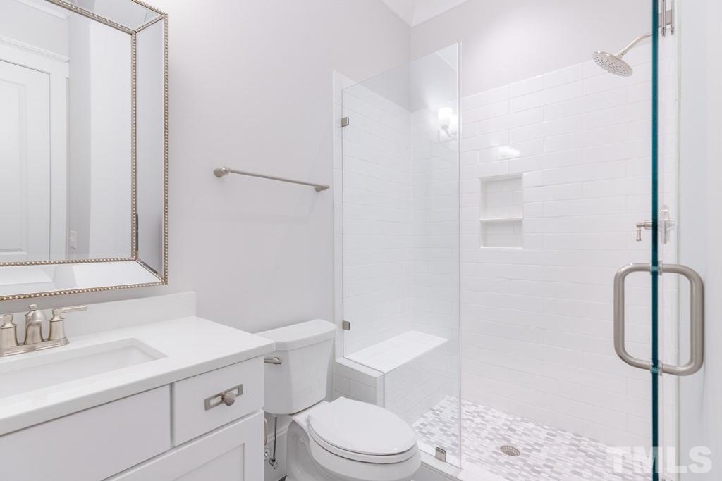 3319 Lake Boone Trail Raleigh, NC 27607 - Photo 18 of 30 a bathroom with a sink toilet vanity and shower