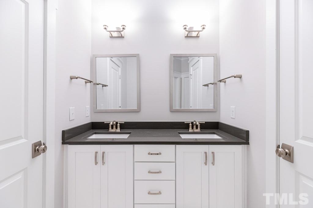 3319 Lake Boone Trail Raleigh, NC 27607 - Photo 20 of 30 a bathroom with a granite countertop sink and a mirror