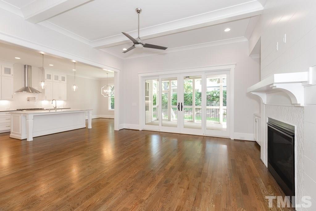 3319 Lake Boone Trail Raleigh, NC 27607 - Photo 4 of 30 a view of an empty room with wooden floor and a kitchen