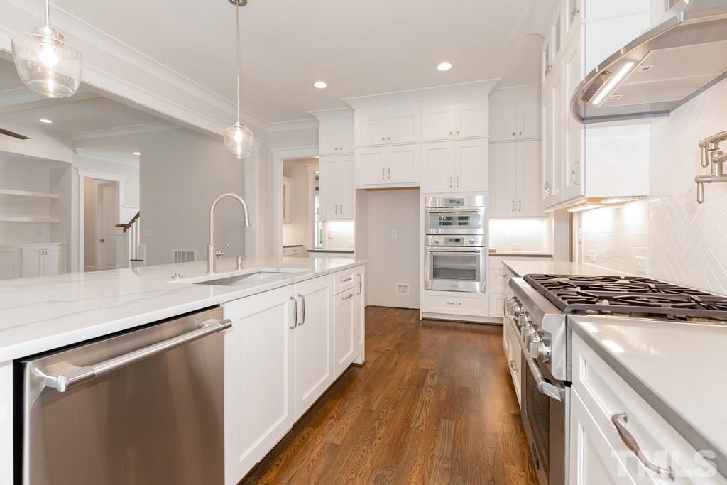 3319 Lake Boone Trail Raleigh, NC 27607 - Photo 6 of 30 a kitchen with stainless steel appliances granite countertop a sink stove and refrigerator