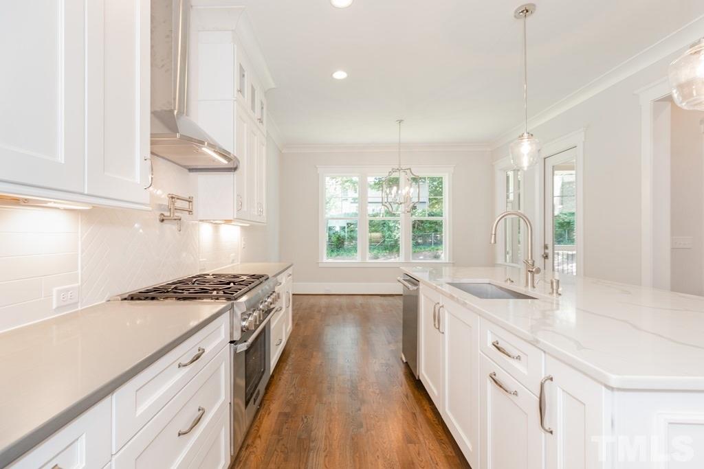 3319 Lake Boone Trail Raleigh, NC 27607 - Photo 7 of 30 a kitchen with stainless steel appliances granite countertop a sink stove and cabinets