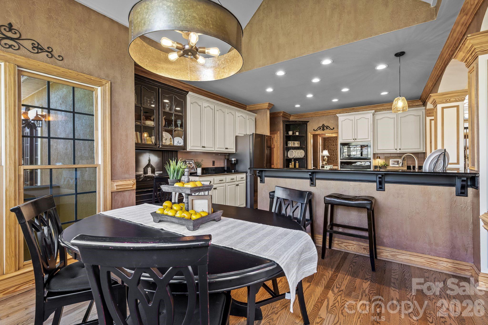 3530 Cardiff Lane Matthews, NC 28104 - Photo 19 of 39 a view of a dining room with furniture and a kitchen view