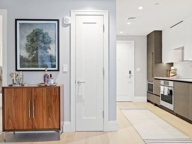 a view of kitchen with stainless steel appliances cabinets and a refrigerator