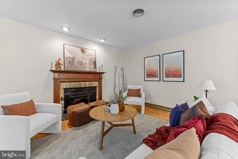 a living room with furniture a rug and a fireplace