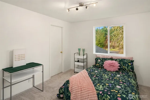 a bedroom with a bed and a window