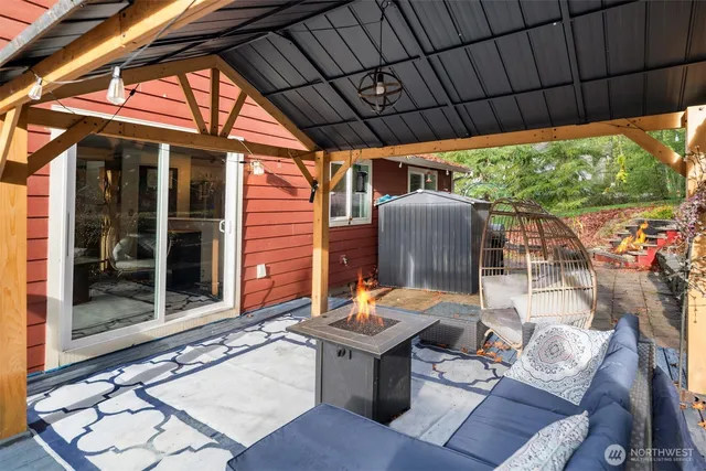 a backyard of a house with yard table and chairs
