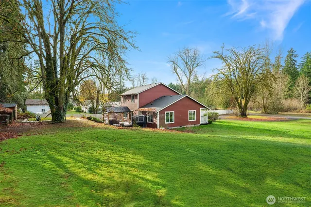 a front view of a house with a yard and trees