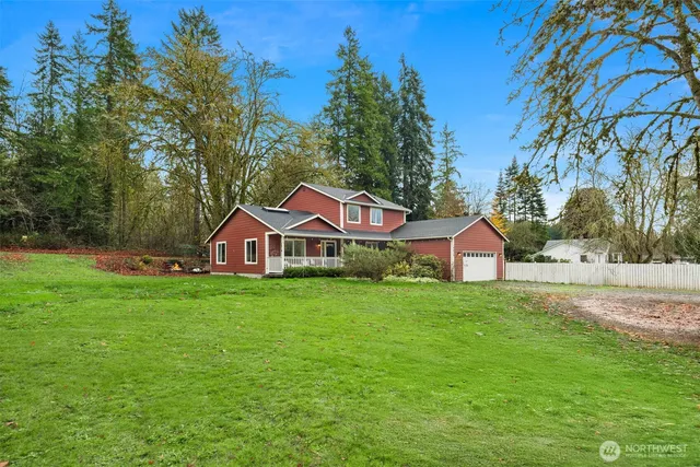 a front view of a house with yard and green space