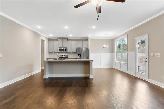 a view of kitchen with refrigerator microwave and wooden floor