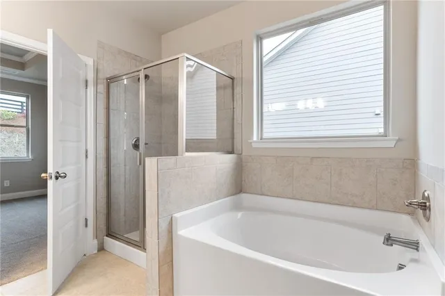 a white bath tub sitting next to a shower