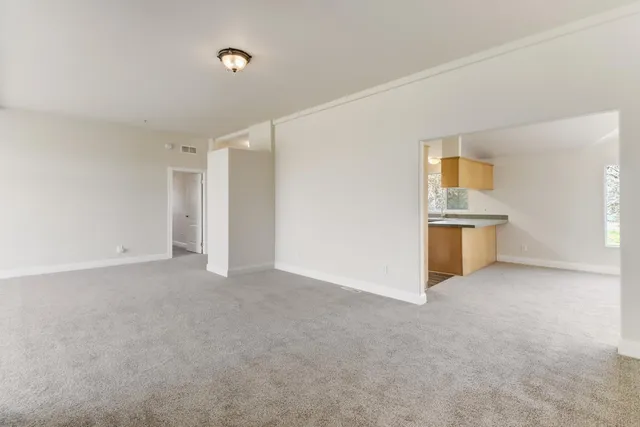 a view of a field with an trees in front of it