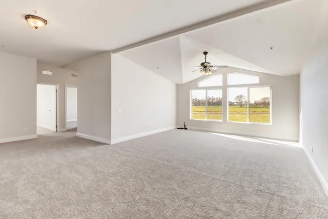 a kitchen with stainless steel appliances a sink a stove and wooden floor