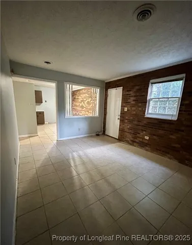 a kitchen with a sink a refrigerator and cabinets