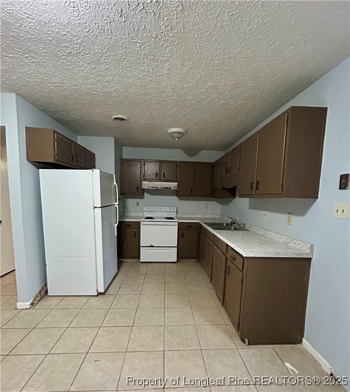 6320 Marykirk Drive, Unit C Fayetteville, NC 28304 - Photo 5 of 14 a kitchen with a sink a refrigerator and cabinets
