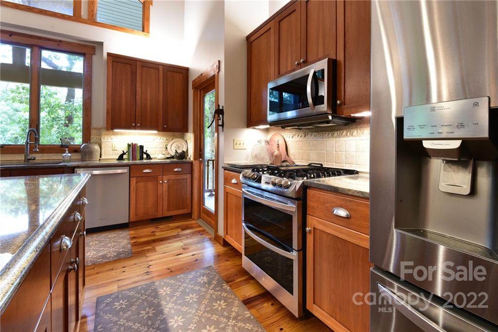 175 Clearview Point Drive Mount Gilead, NC 27306 - Photo 19 of 48 a kitchen with stainless steel appliances granite countertop a stove microwave and sink