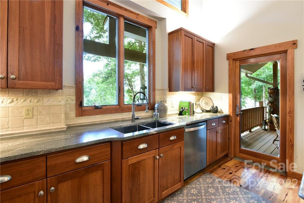 175 Clearview Point Drive Mount Gilead, NC 27306 - Photo 20 of 48 a kitchen with stainless steel appliances granite countertop wooden cabinets a sink and a large window
