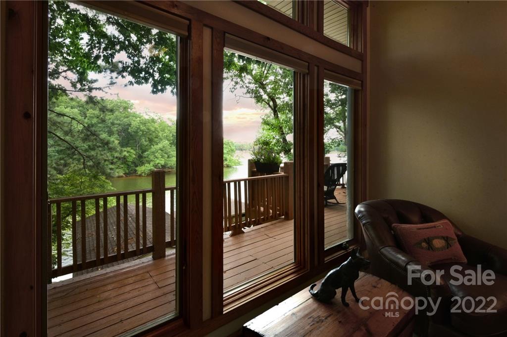 175 Clearview Point Drive Mount Gilead, NC 27306 - Photo 23 of 48 a view of a balcony with chair and wooden floor